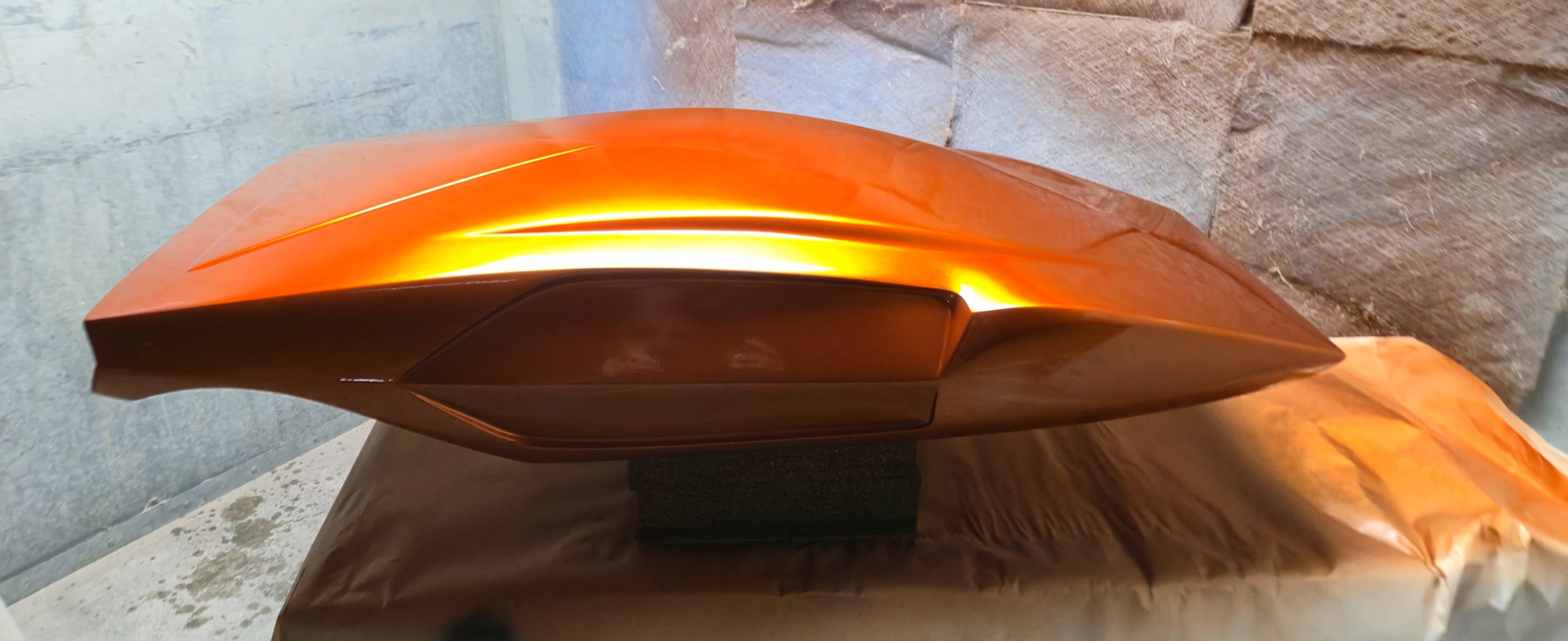 The finished Lancia Zero plaster art sculpture in candy orange paint