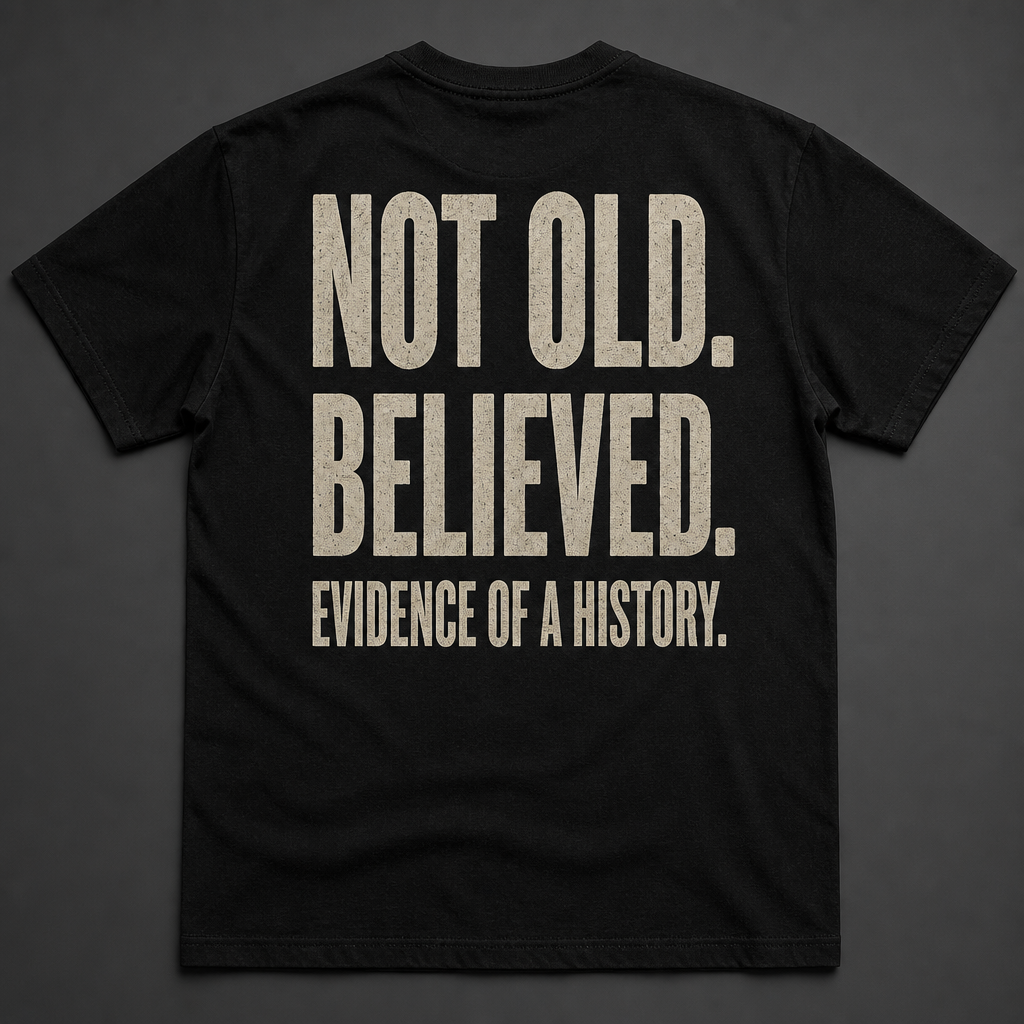 Back of black t-shirt reading NOT OLD. BELIEVED. EVIDENCE OF A HISTORY.