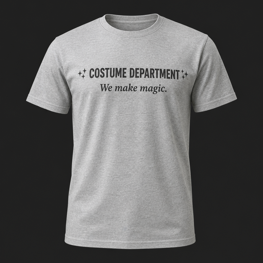 Front of heather navy t-shirt reading COSTUME DEPARTMENT, We make magic with sparkle accents